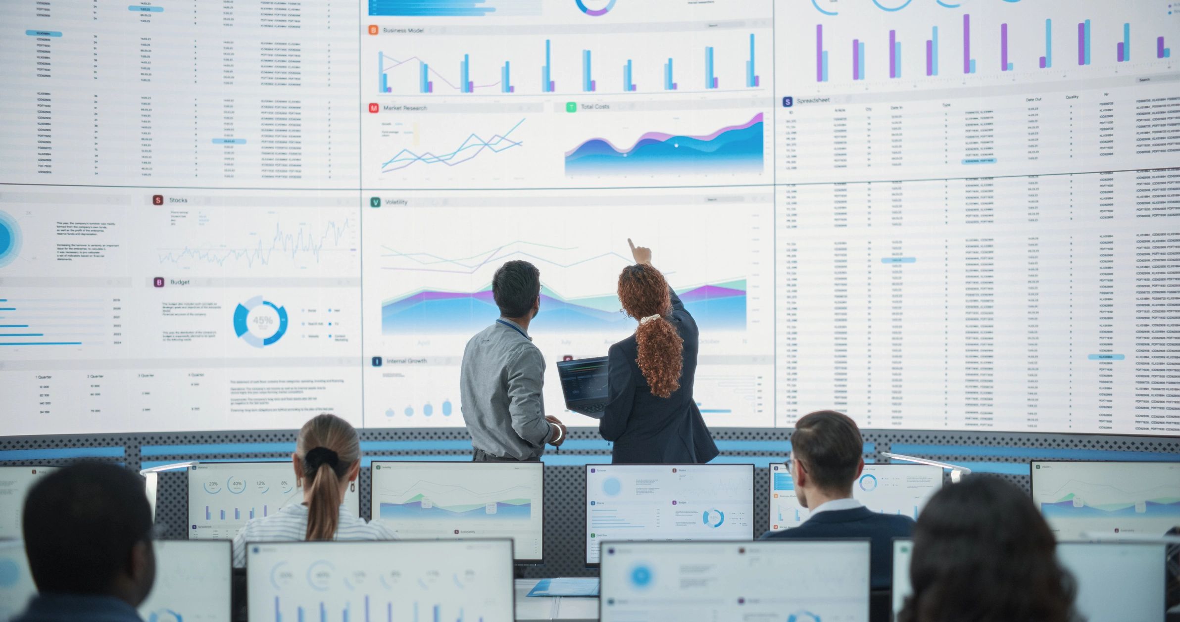Technology team working with data and digital systems in a modern operations room